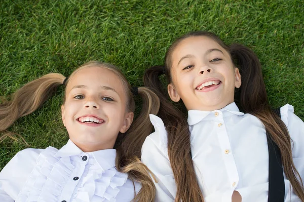 Счастливого детства. Счастливые дети отдыхают на зеленой траве. Наслаждаюсь детскими годами. Защита детства. Детский центр. Детское счастье. Международный день защиты детей — стоковое фото