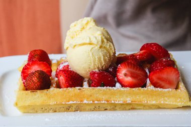 Çilekli Belçika waffle 'ları ve bir kepçe dondurma..