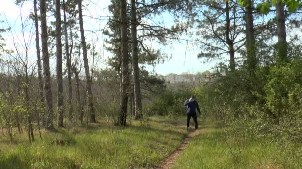 Man Talking Cell Phone Climbs Forest Path — Stock Video