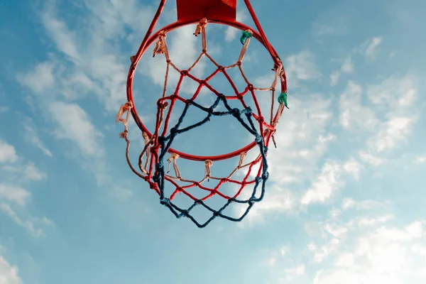 Баскетбольное Кольцо Цветной Сеткой Против Голубого Неба Белыми Облаками — стоковое фото