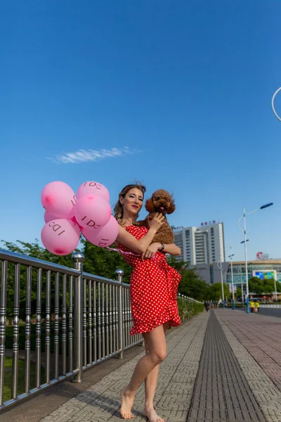 portrait of a girl with pink balloons