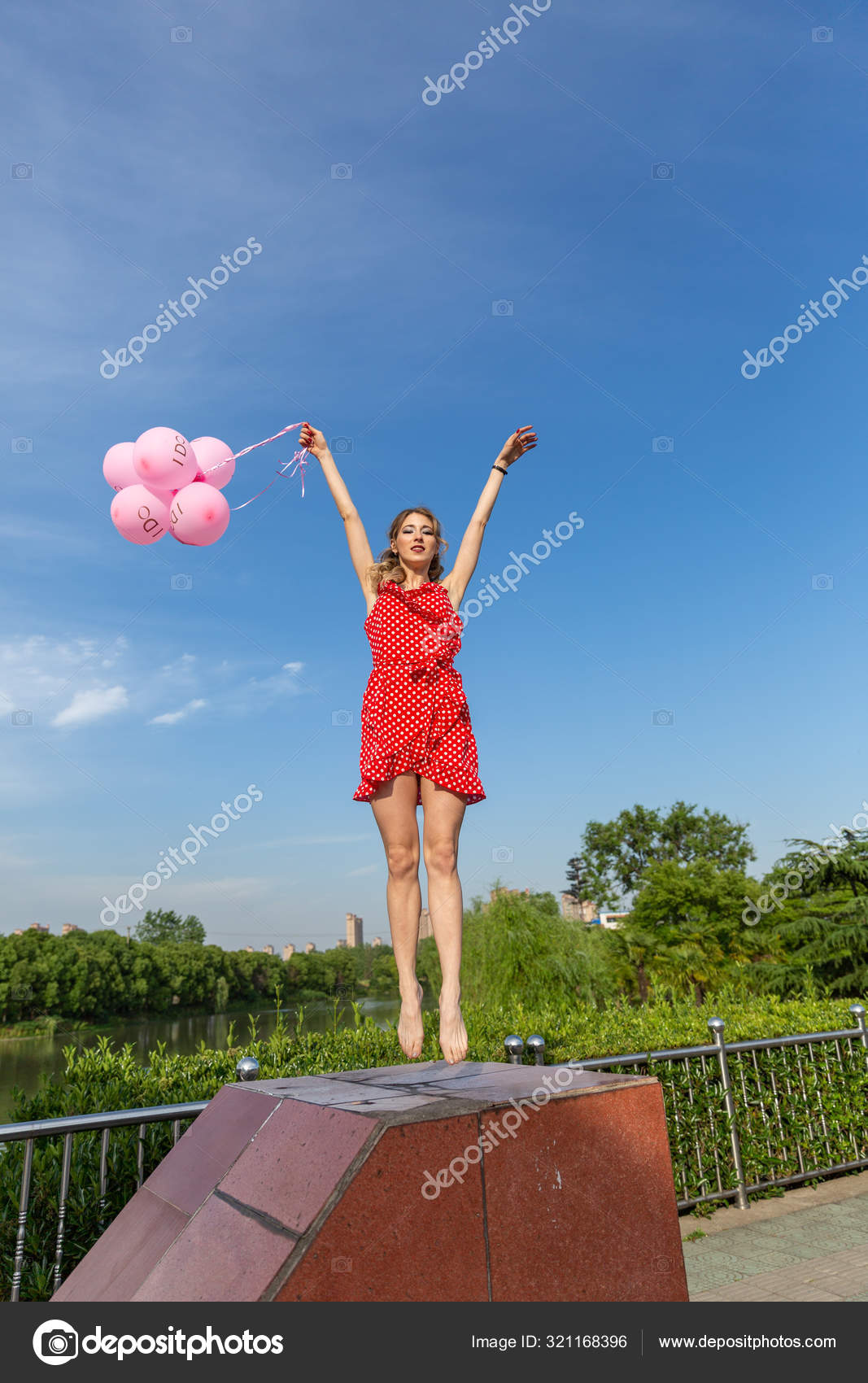 https://st3.depositphotos.com/27614600/32116/i/1600/depositphotos_321168396-stock-photo-girl-red-dress-posing-balloons.jpg