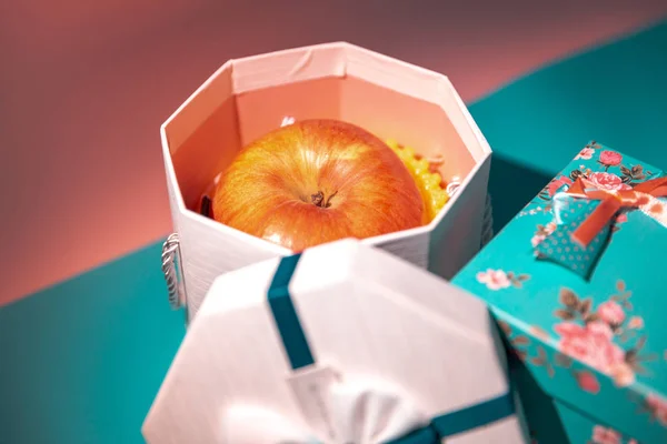 close up of apple in colorful gift box