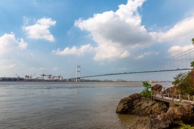 view on bridge with blue sky and beach.