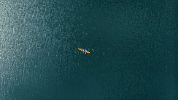 aerial view of people in kayaks floating on the sea