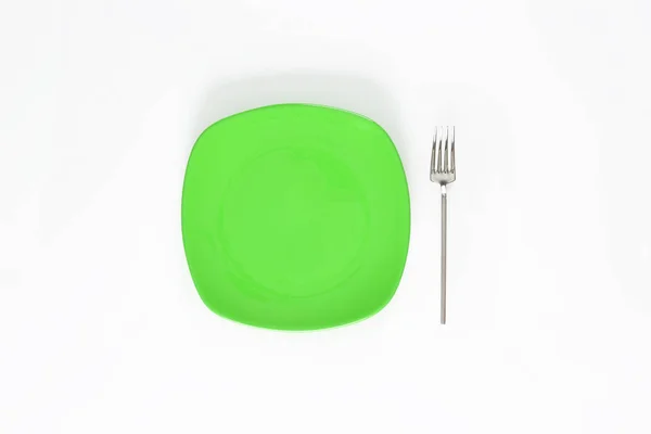 Placa Color Verde Césped Vacío Tenedor Junto Objeto Aislado Sobre —  Fotos de Stock