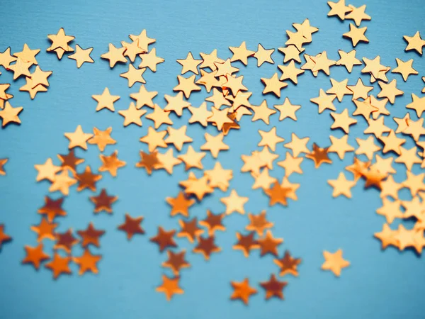 Golden stars glitter on blue background