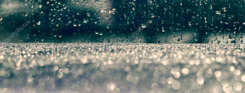 Rainy drops on the glass with the dark blue blurry background Stock Picture