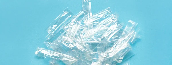 Pile of transparent plastic wrapping rubbish on a blue background. — Stock Photo, Image