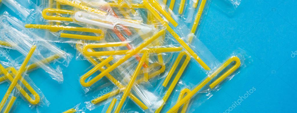 Pile of yellow drinking straws on a blue background Royalty Free Stock Images