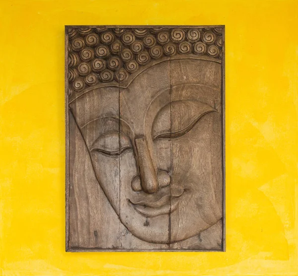 Face of a buddha wood handmade.Sculptures in the temple.