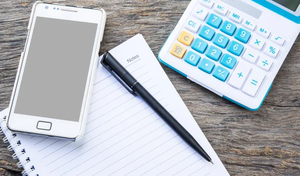 note paper with calculator, mobile, telephone and pen on table, vintage filter