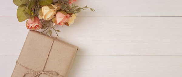 Красивый цветок и подарочная коробка на деревянном фоне с романтическим, подарки на День матери или Валентина день с пастельным тоном, украшение на рабочем столе, праздничная концепция, баннер сайт
.