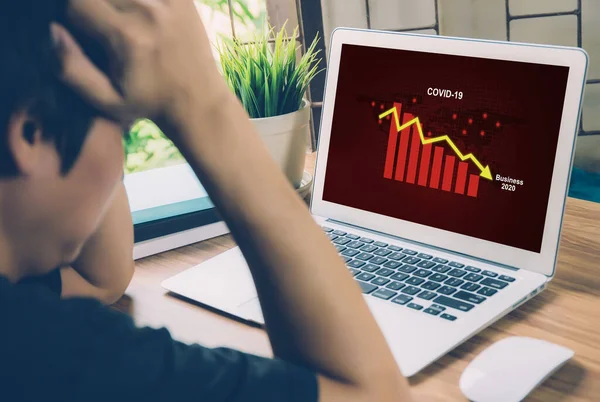 Businessman panic about financial of business with graph chart and diagram, disease covid-19 impact crisis economic with frustrated and stress, failure and problem of economy with fall down.