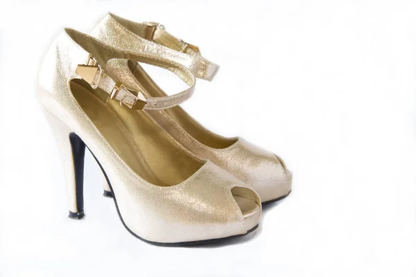 Pair of gold women's high-heeled shoes Royalty Free Stock Photos