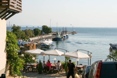 Nesebar, Bulgaria, July 23, 2012. Old Town of Nesebar. View of the pier from the restaurant, high-speed boat, tugs in the port of Nessebar.