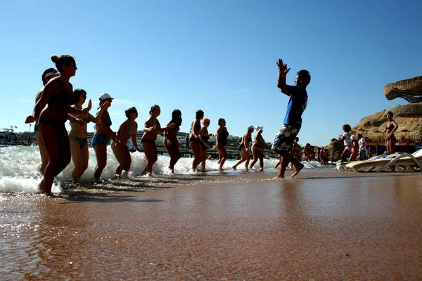 Sharm el Sheikh, Egypt. Dec 07, 2008.  Women synchronized dance on the shore of the Red Sea. Animation of the masses at the beach.