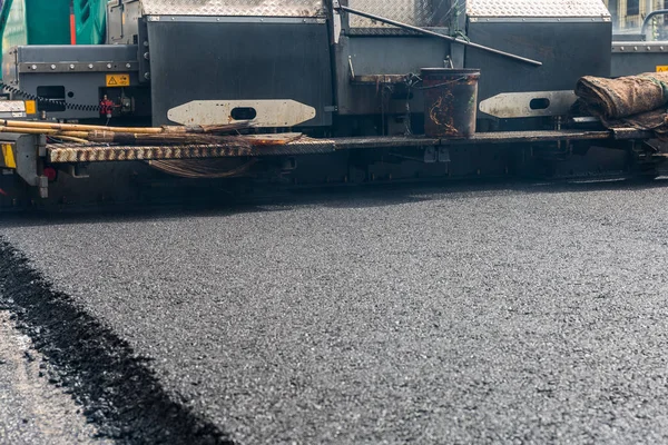 Asphalt paver machine during road construction. — Stock Photo, Image