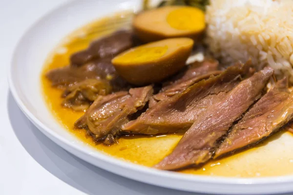 Stewed pork leg on rice. — Stock Photo, Image