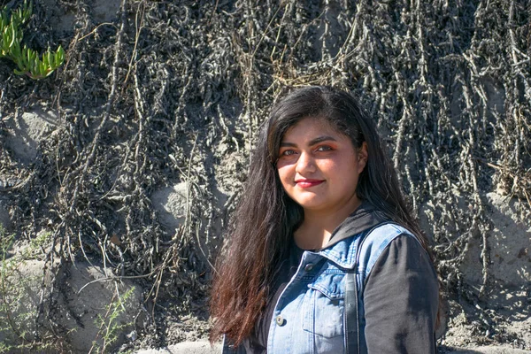 chubby woman with latin or hindu appearance walking in the park