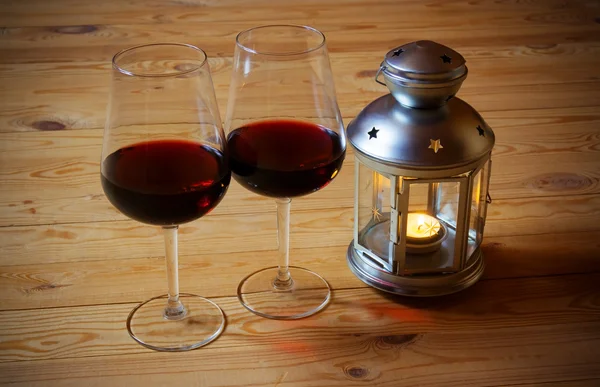 Вино и фонарь на деревянном фоне — стоковое фото