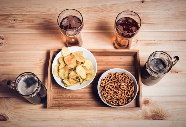Beer and beer snacks on wooden table. Vintage style