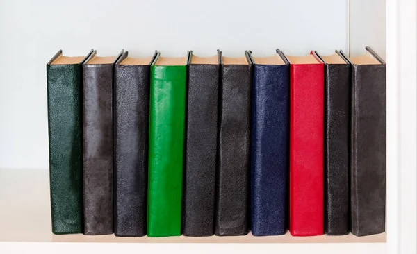 Different books on white shelf — Stock Photo, Image