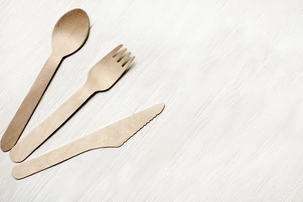 Disposable tableware from natural materials, wooden spoon, fork, knife, eco-friendly. Place for text