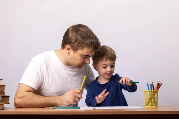 Little Boy Dad Sits Desk Books Selects Pencil Gray Background — Stock Photo, Image