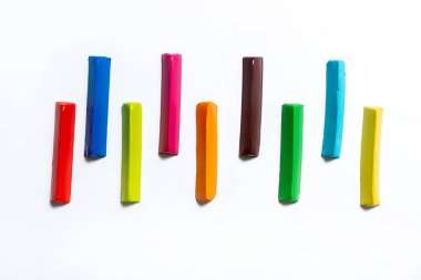 Çok renkli plastik çubuklar beyaz arka planda paralel olarak serilmiştir. İzole et. metin için yer