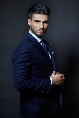 Stüdyoda mavi elbiseli şık bir adam.