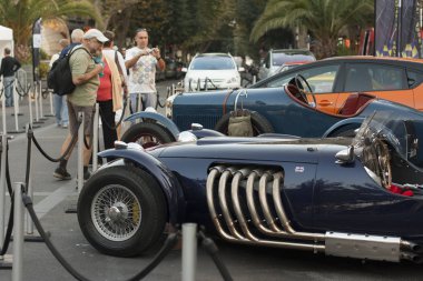 Antibes France 13. Oct 2008.  Oldtimer jaguar with six shiny bent exhaust pipes.