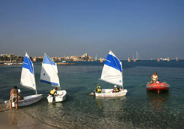 Antibes France 13. Oct 2008.  Kid sailors school, small sailboat. Students of Club Nautique d'Antibes with small sailboats in Plage du Ponteill Bay.