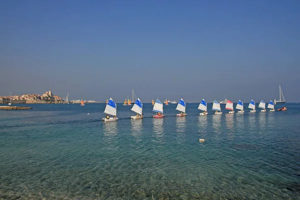 Antibes France 13. Oct 2008.  Kid sailors school, small sailboat. Students of Club Nautique d'Antibes with small sailboats in Plage du Ponteill Bay.
