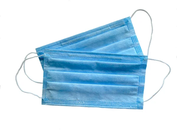 Mavi tıbbi maske beyaz arka planda izole edildi. Tıp ve sağlık kavramı..