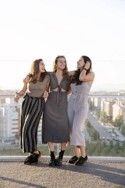 Group of three female friends walking in the street — ストック写真