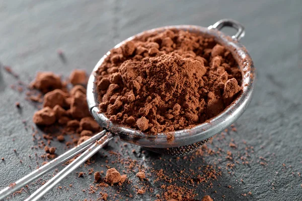 sieve with cocoa powder close-up