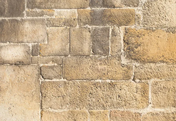 sandstone wall worked by a stonemason