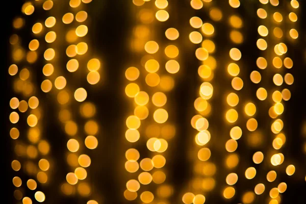 Background of gold and black glitter lights. Defocused