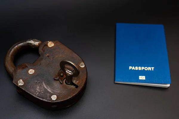 Blue passport with vintage lock and key. Coronavirus, safety and travel concept. Closing borders between countries due to virus