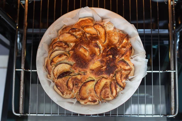 Delicious apple pie freshly baked at home in the oven. Apple Charlotte Homemade baking. Vegan cake in a baking dish. top view, flat lay