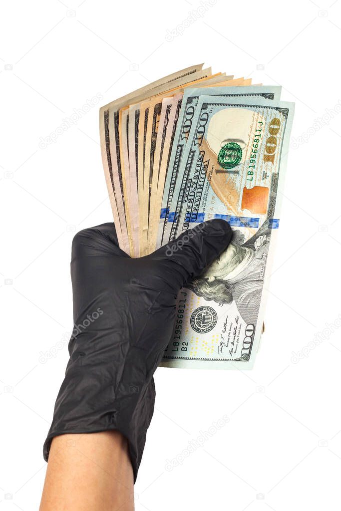 Hand in medical gloves holding a pack of dollars. The concept of infection for money, dirty money, paid drugs, treatment fees, bribes, illegal operations. Isolated on white background