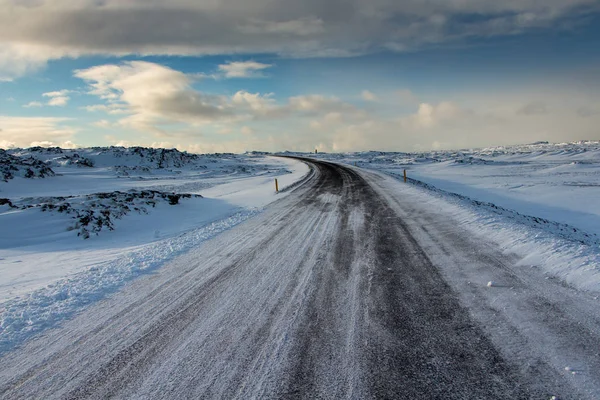 Icy road in Iceland across on a lava field. beautiful winter scene.