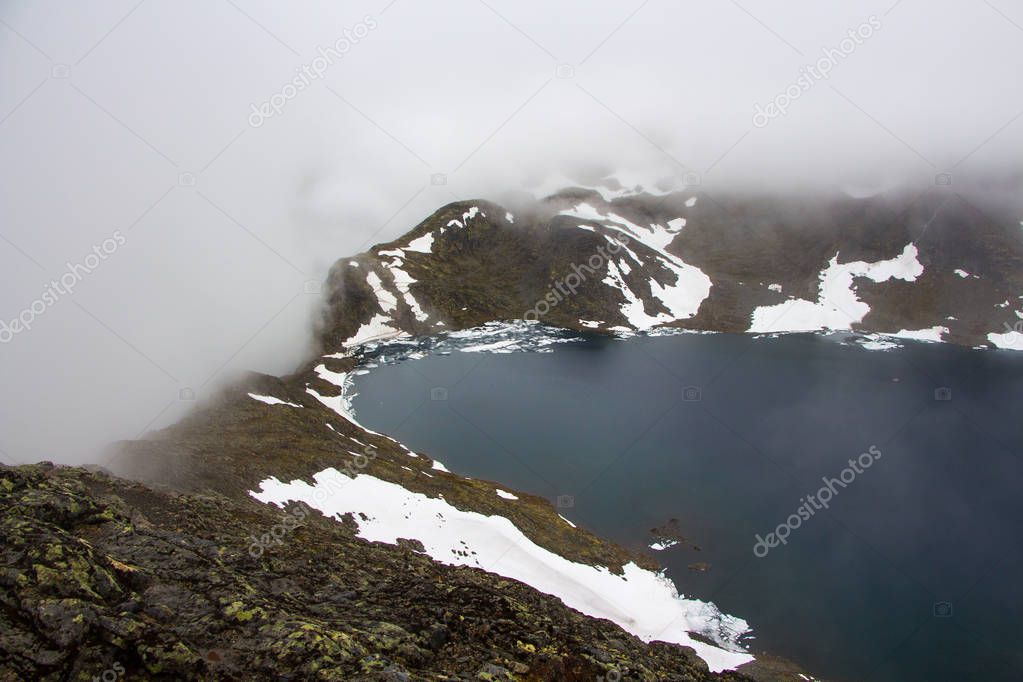 Misty landscape of Besseggen ridge Norway, a famous hiking route.
