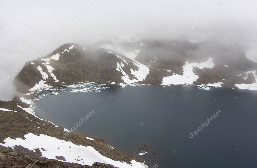 Misty landscape of Besseggen ridge Norway, a famous hiking route.
