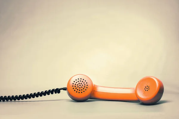 Orange handset on table — Stock Photo, Image