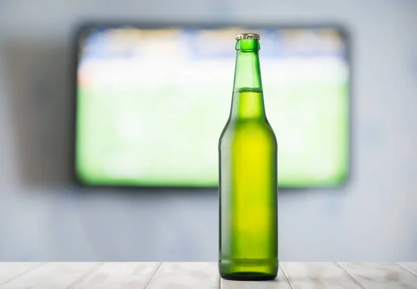 Beer on table and TV — Stock Photo, Image