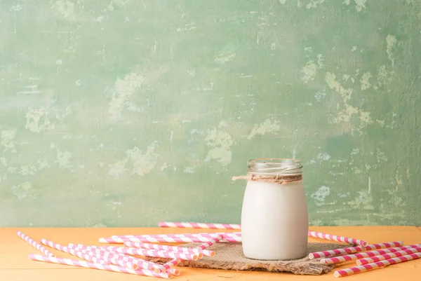 A bottle of milk and straws — Stock Photo, Image