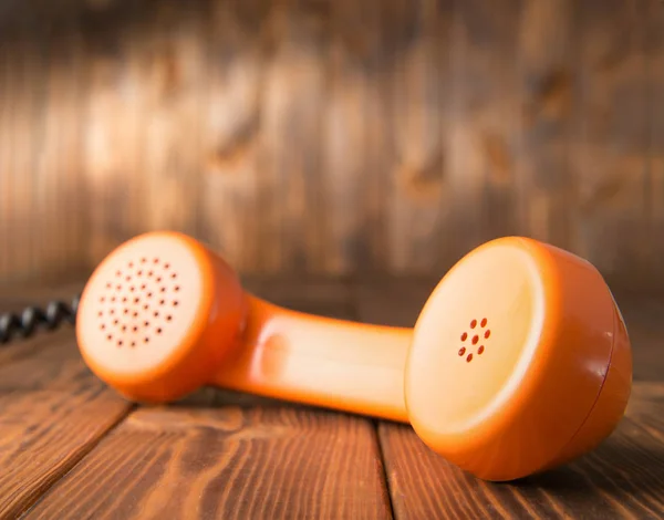 Handset on wooden table — Stock Photo, Image