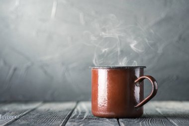 Brown mug of hot tea on table  clipart